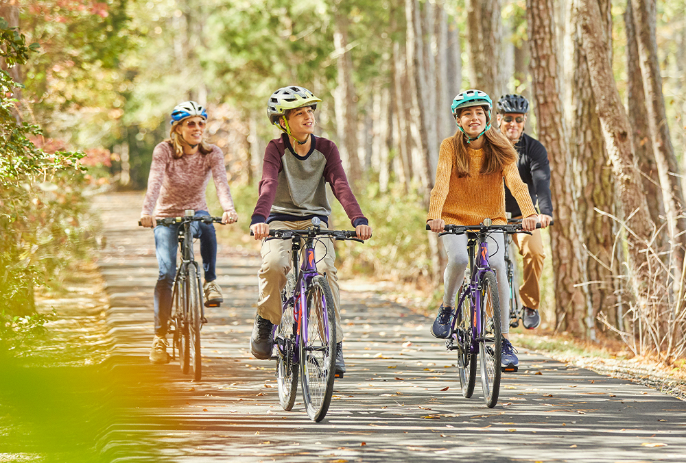 A family riding their bikes together in Williamsburg, Virginia.