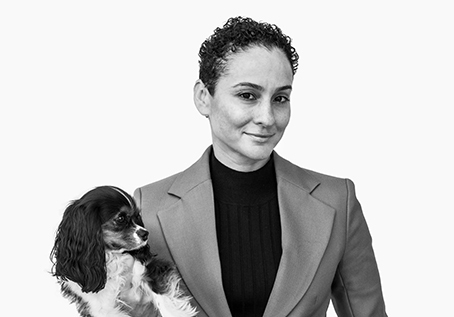 Tiara "T" and her dog pose for a black and white portrait photo.