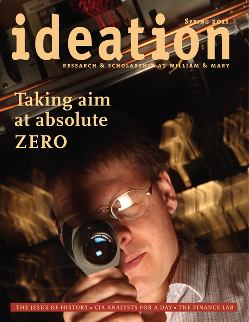 Cover of Ideation Magazine for spring 2011 issue. Cover feature headline: Taking aim at absolute zero. Professor Seth Aubin looking through the special scope used to see a cloud of cold atoms.