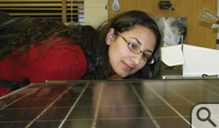 Sabina Samipour '11 inspects the large solar panel destined for the Small Hall rooftop.