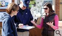 Katie Moriarty, an M.B.A. student at the Mason School of Business at the College of William & Mary, discusses the idea of a community-supported fishery with a pair of festival-goers during the 2nd Sundays Williamsburg Arts and Music Festival in March.