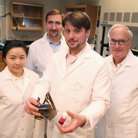 Post-doctoral chemist Jaeton Glover (center) displays samples of polymers reinforced with graphene oxide. 