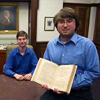 Latin-literate physics student Jackson Olsen ’16 displays William & Mary’s copy of Isaac Newton’s Principia