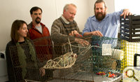 Traps from all over: VIMS researchers (from left) Donna Bilkovic, David Stanhope, Kory Angstadt and Kirk Havens look over their world-wide collection of traps for harvesting sea creatures.