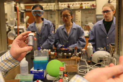 Chemist William McNamara discusses next steps in developing and testing metal catalysts with lab members (from left) master’s student Dan Liu, Wanji Zhang ’15 and Carolyn Hartley ’16.