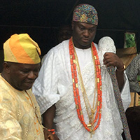 Gérard Chouin (center) confers with Yoruba leader the Ooni of Ife (second from left) on an archaeological site in Nigeria. 