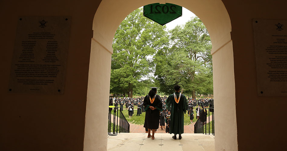 Looking out over the heads of student leaders speaking to graduates gathered in the Wren Courtyard in commencement attire