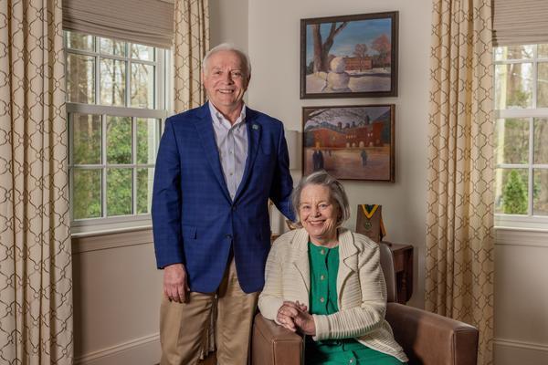 Rob and Jean Estes smile in their home