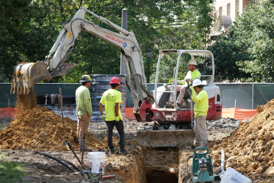 A construction crew installs wells for the geothermal system that will heat and cool Monroe Hall.