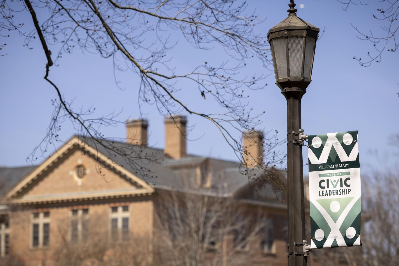Year of Civic Leadership Banner on a lightpole with a building in the background.