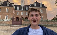 A student selfie in front of the Capital building in Colonial Williamsburg at sunset