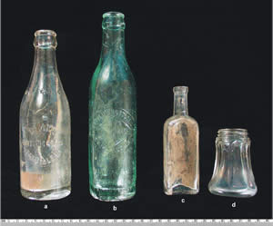 Bottles and a salt shaker (d) from 44PY181. All three bottles were embossed with manufacturers' names.