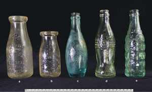 The large numbers of whole bottles found at both sites reflects the mass production already underway by this time. The upper photo shows two milk bottles from local dairies, a fruit juice bottle, the well-known Coca-Cola bottle, a container for a soft drink called 'Good Grape.'