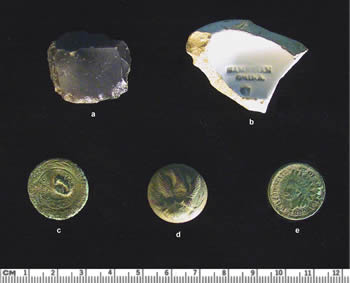 Historic-period artifacts from the additional test units range in date from the late 18th century through the late 19th century. The gunflint, pearlware ceramic sherd, and brass button (a—c) could be from the initial use of the property by the Gilliams. The maker's mark 'Cambrian China' traces the sherd's origin to a pottery in Wales, an unusual source at a time when England dominated the ceramics market in North America. Later artifacts include a General Services military button (d), most likely from the Civil War, and an 1883 'Indian Head' penny.