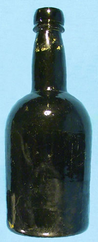 Liquor bottle from the mid-1800s with remnants of the paper seal still visible on the neck (about 8 inches tall).