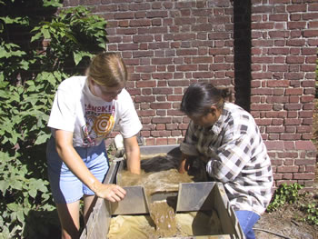  In a process called flotation, bags of soil from Feature 8 are washed through fine screens until the small sample remains. 