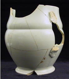 The mended jug is a ceramic type called 'whiteware,' common on sites dating to the mid-1800s.