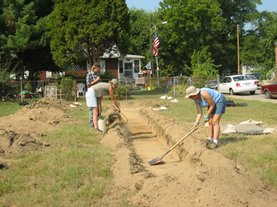 Once a trench has exposed the subsoil, careful examination and further shovel scraping reveals archaeological features. Examples include old pits, postholes, and cellars too deep to have been disturbed by later ground-disturbing activities like plowing.