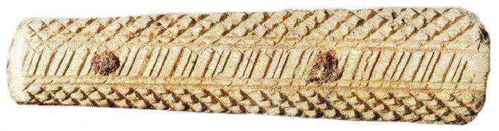 Decorated bone handle of fork from earlier structure [2.75 inches long].