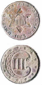 Both sides of a U.S. 3 cent coin (1853) found in the later structure at the site, which burned in the 1880's. Issued from 1851 to 1873, these are the smallest of American silver coins [0.6 inches in diameter].