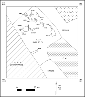 Collection of artifacts resting at the base of a subfloor pit in Structure 2.