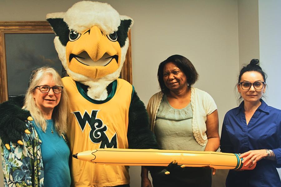 Griffin mascot poses with 3 Workday Project team members to celebrate the Pencil's Down milestone