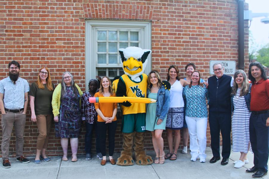 Griffin mascot poses with Workday Project team members to celebrate the Pencil's Down milestone