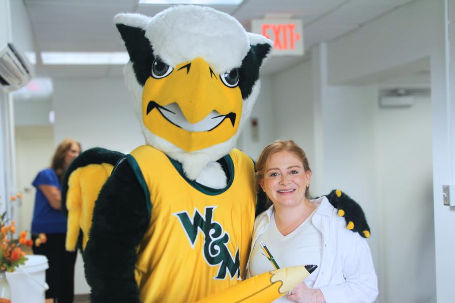 Griffin mascot poses with a Workday Project team member to celebrate the Pencil's Down milestone