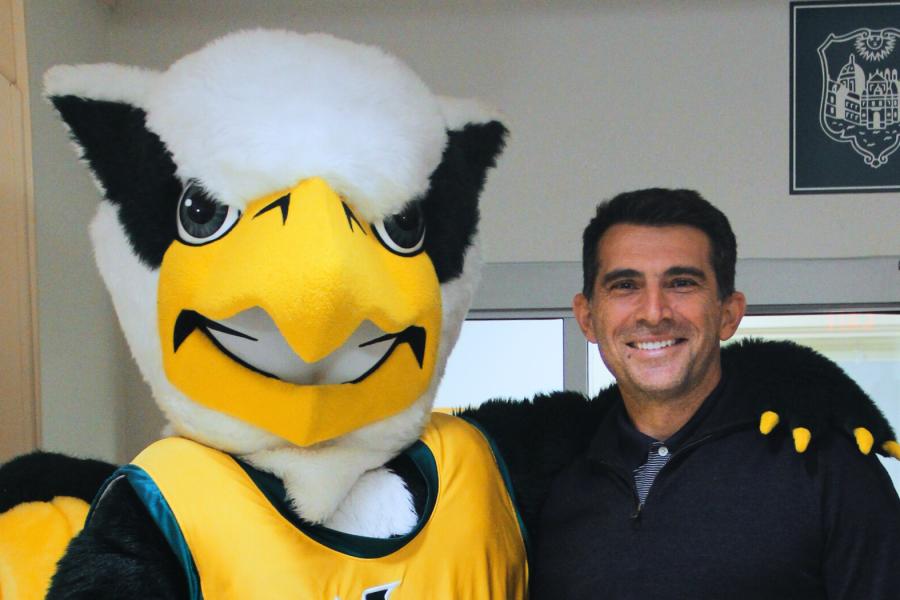 Griffin mascot poses with a Workday Project team member to celebrate the Pencil's Down milestone